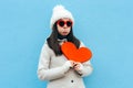 Heartbroken Sad Upset Girl Holding a Heart on Blue Background Royalty Free Stock Photo